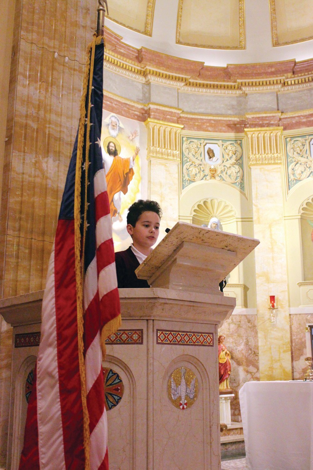 PATRIOTIC PRAYERS: St. Rocco School held its Veterans Day Prayer Service Wednesday, Nov. 9 at St. Rocco Church, 931 Atwood Ave., Johnston. Students from St. Rocco School read poems that they wrote, carried photos of loved ones, sang patriotic songs and prayed for all veterans.  Also, the school held a “Dress Down Day” for "Operation Christmas Stocking" where students dressed in red, white and blue, along with donating a dollar for the cause. Proceeds will go toward filling stockings for soldiers in the 43rd MP Brigade.